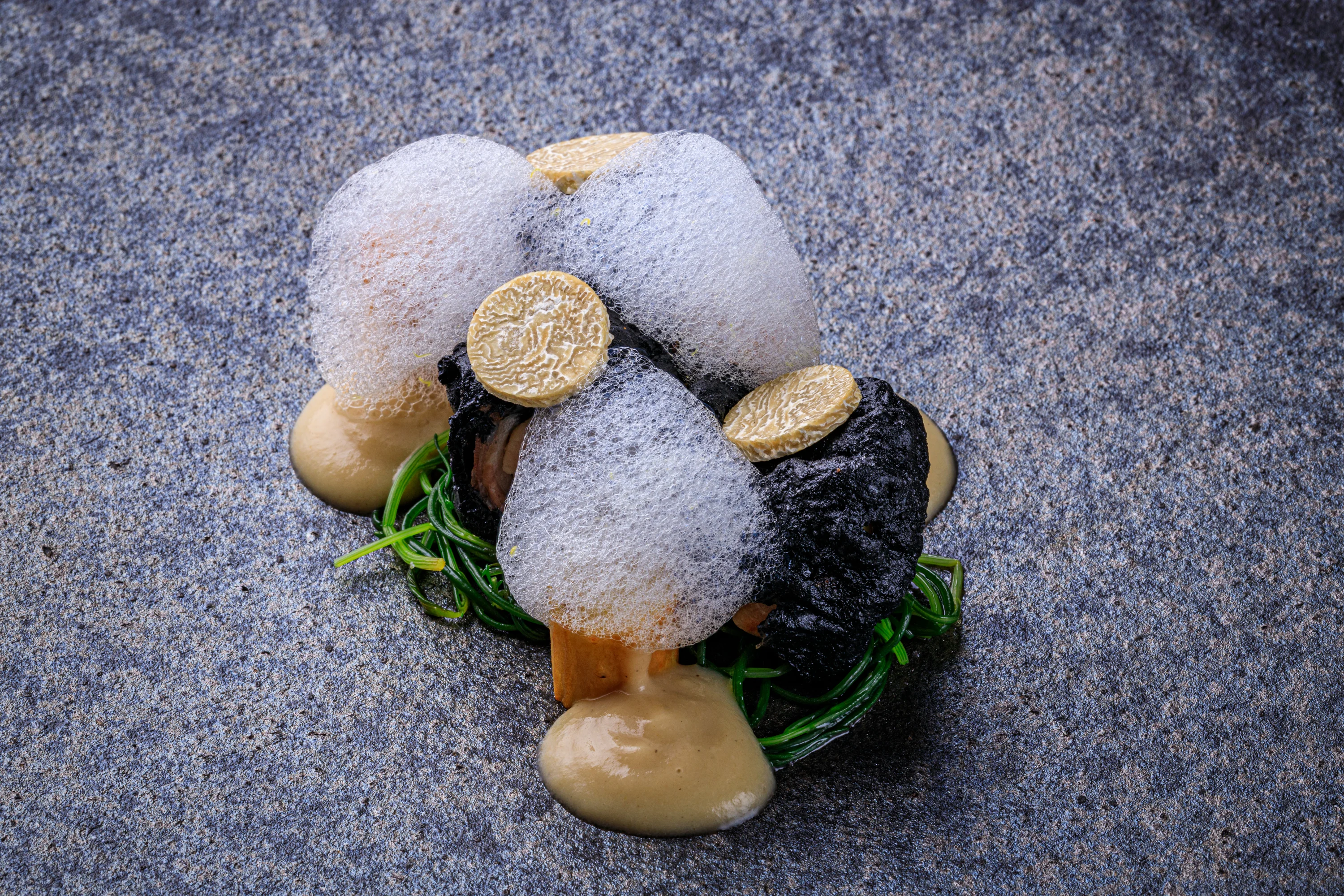A geometric dessert in yellow and purple with crisp honeycomb.