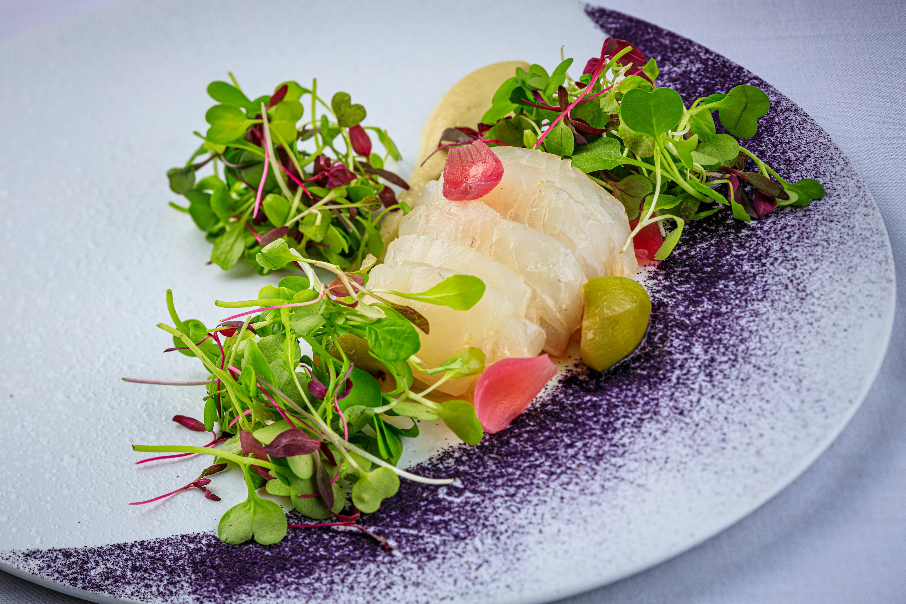 A colorful salad of greens, radish and edible flowers.