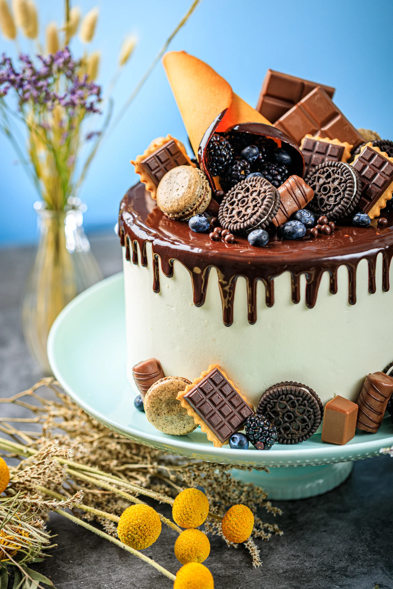 A berry-topped celebration cake with a handwritten plaque.