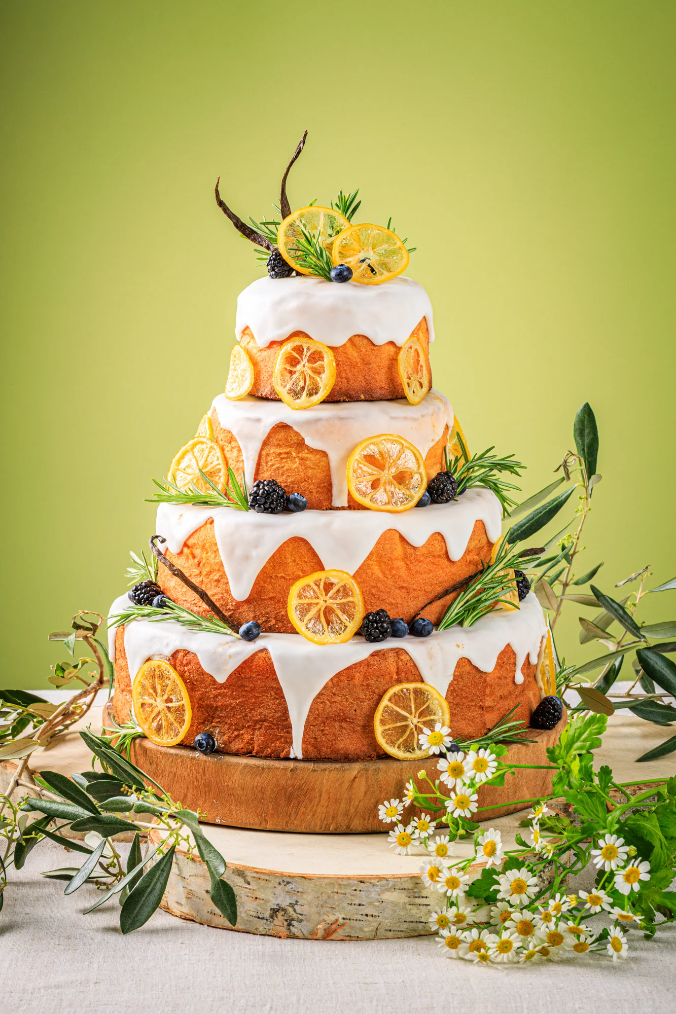 A minimal white tiered wedding cake with delicate floral details.
