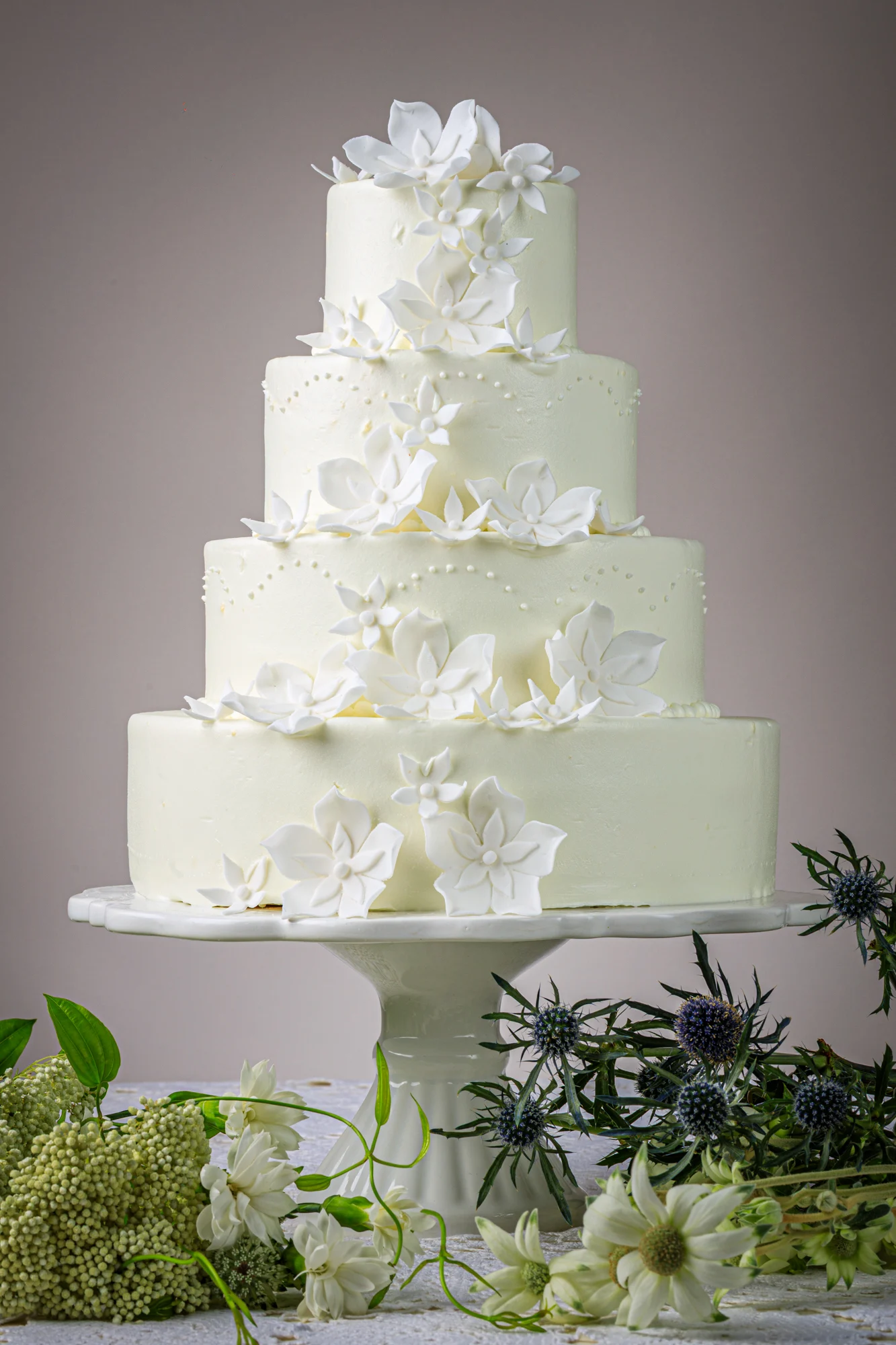 A rectangular strawberry celebration cake photographed outdoors.